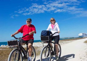 retire baby boomer leisure exercise sun bike beach elderly old couple