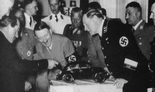 46. Ferdinand Porsche (yeah, that Porsche) showing a model of the Volkswagen Beetle to Adolf Hitler in 1935 46. Ferdinand Porsche (yeah, that Porsche) showing a model of the Volkswagen Beetle to Adolf Hitler in 1935