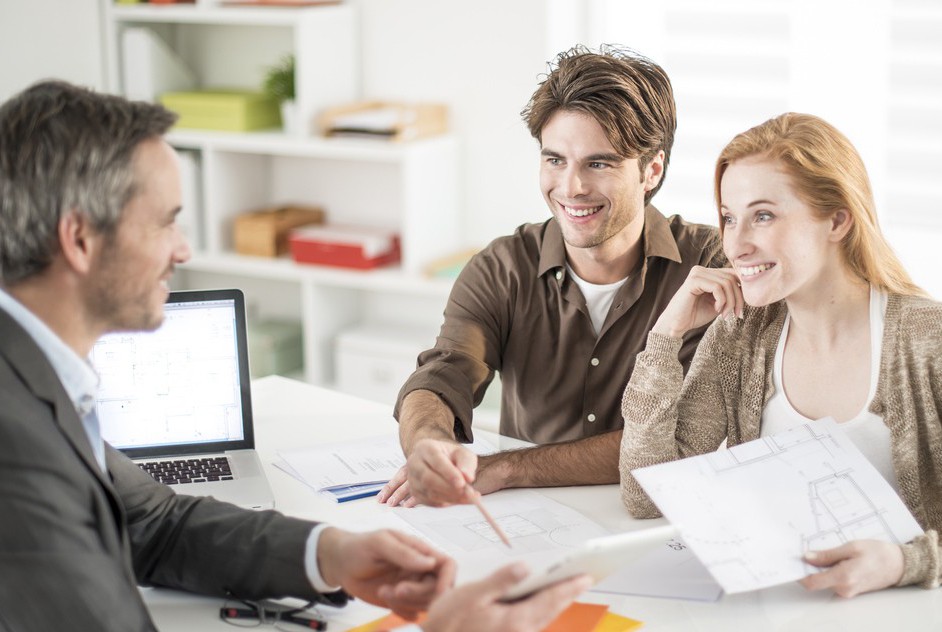 real-estate agent receives a young couple interested to invest i