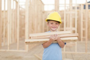 Young Boy Dressed As Carpenter With Hardhat And Tools
