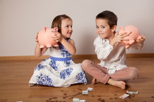 Children Holding Their Piggy Bank