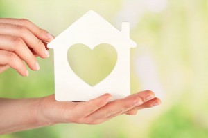Female Hands With Model Of House