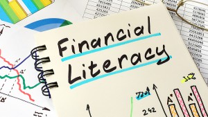 Financial Literacy Written On A Notepad Sheet. Education Concept.