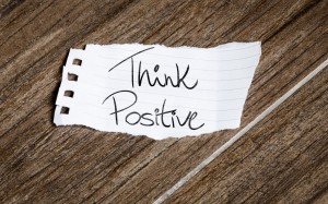 Think Positive Written On The Paper On A Wood Background